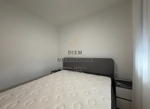 Furnished bedroom with a double bed and white walls. - image 11