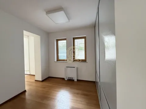Empty room with wooden flooring, two windows and a large built-in wardrobe. - image 11