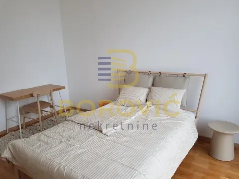 Bedroom with a double bed and a desk. - image 9