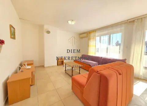 Living room with a sofa and dining area. - image 15