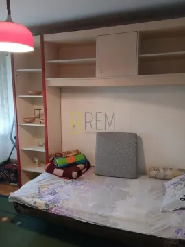 Living or bedroom with a bed and built-in units. - image 9