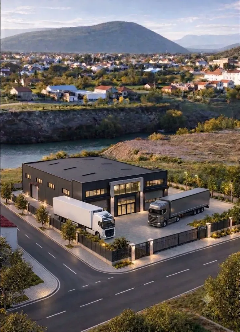 Aerial view of a modern industrial building with trucks in the yard.