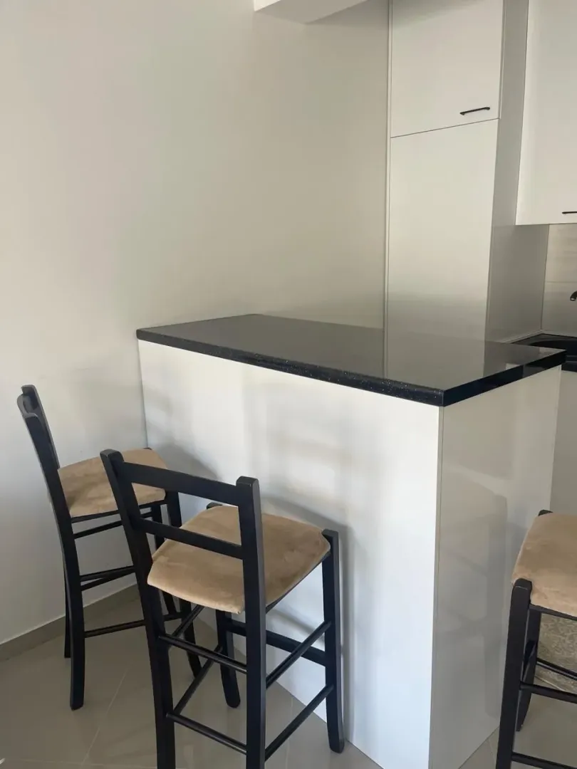 Modern kitchen with a breakfast bar and bar stools.