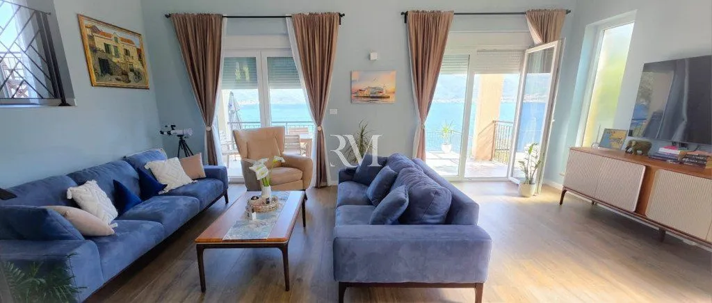 Spacious living room with a sofa set and a sea view.