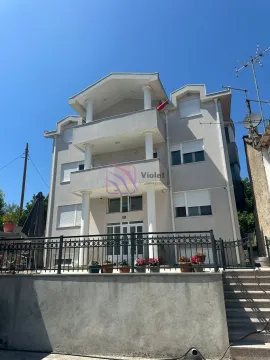 Front view of a multi-story residential building with balconies and a courtyard fence. - image 23