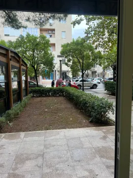 View from the property overlooking the courtyard, street, and parked cars. - image 8