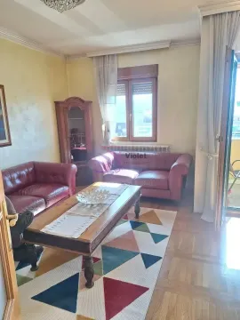 Living room with leather sofas, a wooden coffee table, and a geometric pattern rug. - image 2