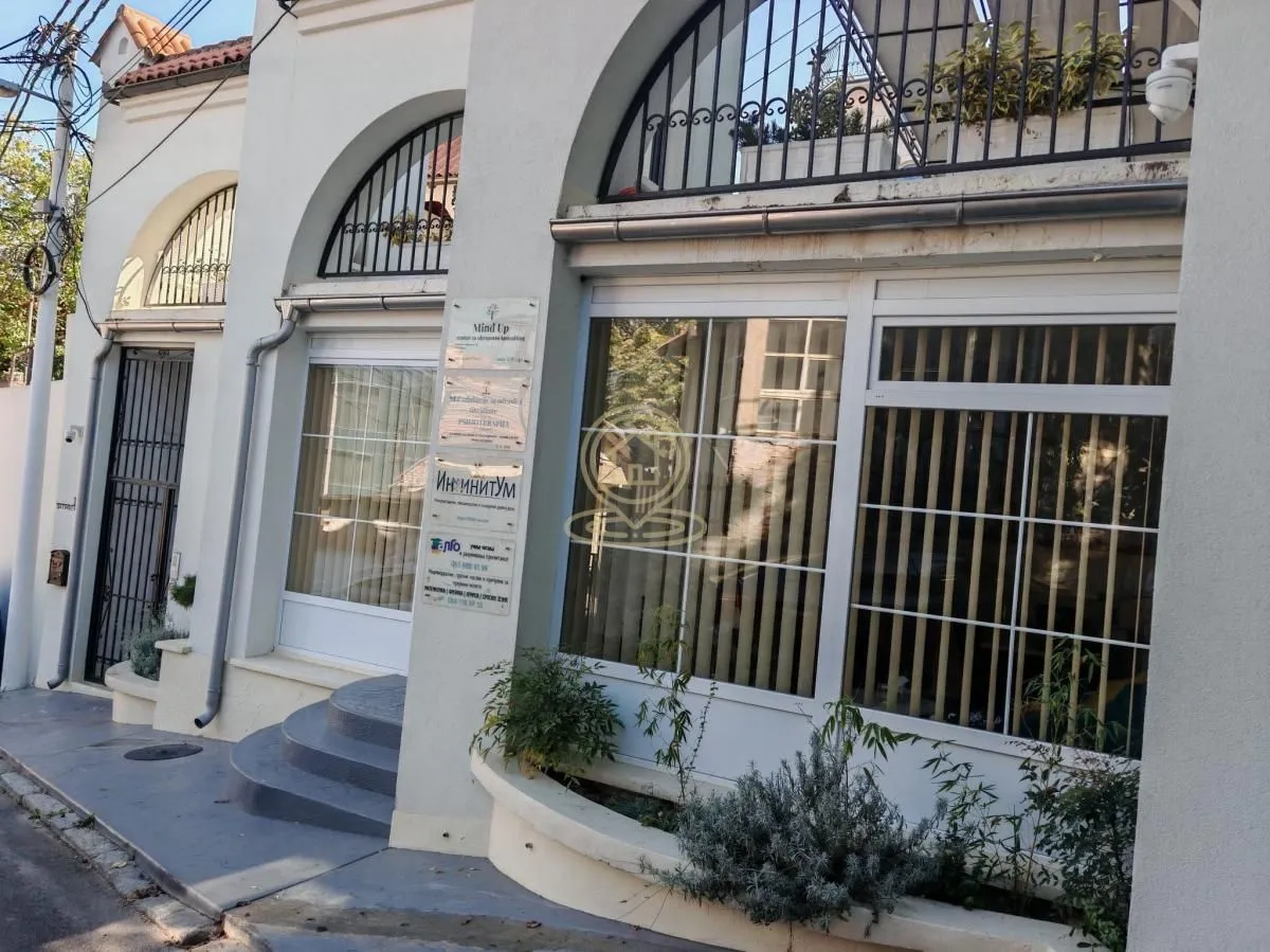 View of the exterior of the building with an entrance and large windows.