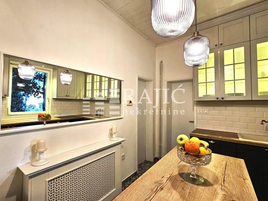 Modern kitchen with wooden elements and a dining table.