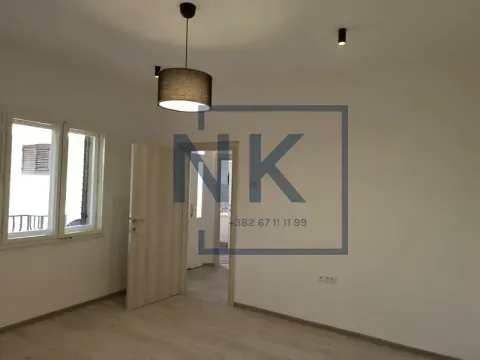 Empty room with two windows, white walls and wooden flooring. - image 7