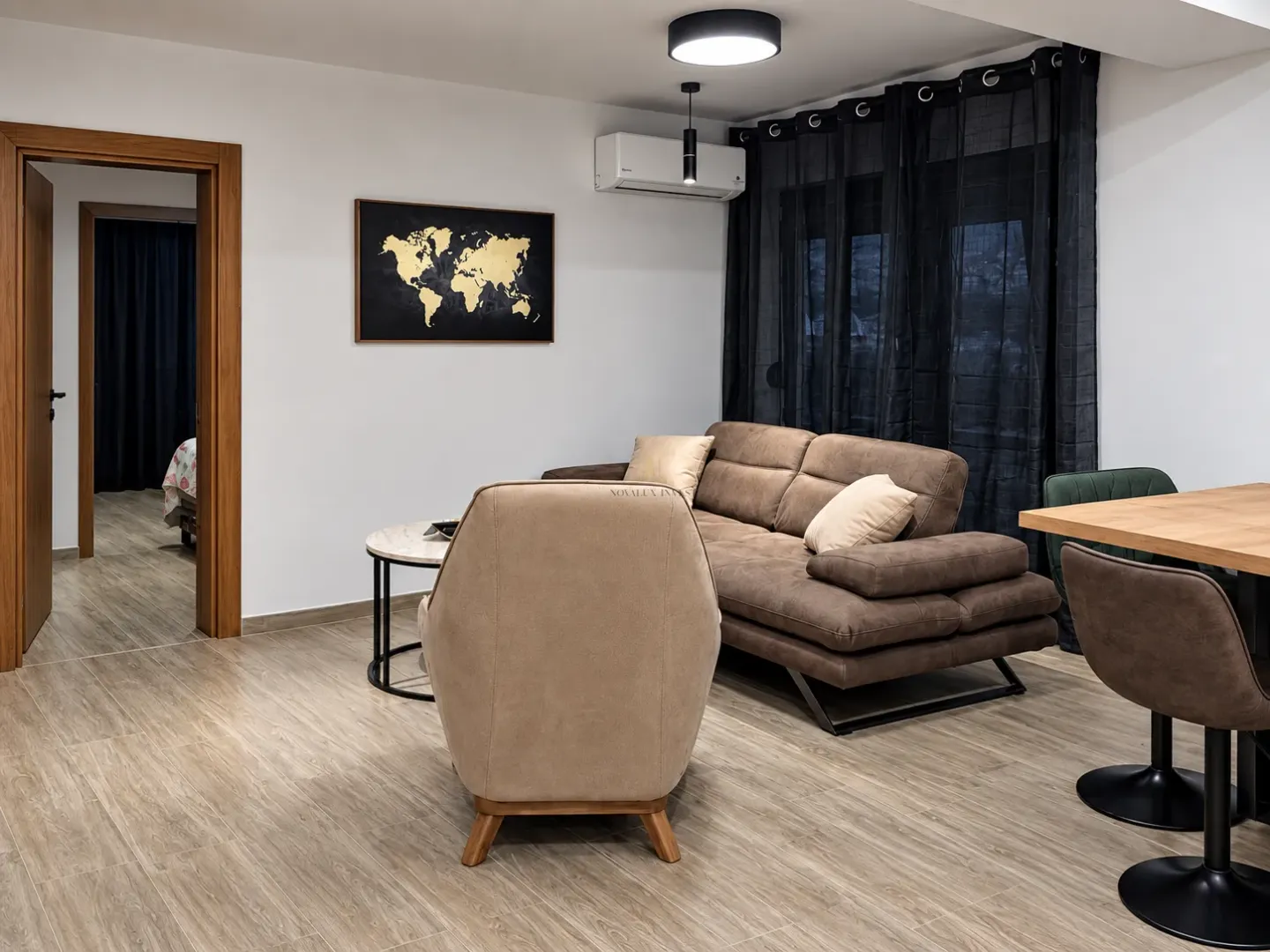Living room with sofa set, armchair, and dining table.