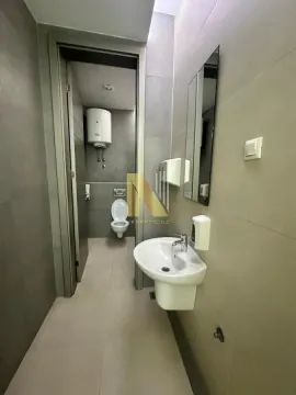 Modern bathroom with a sink and toilet. - image 9