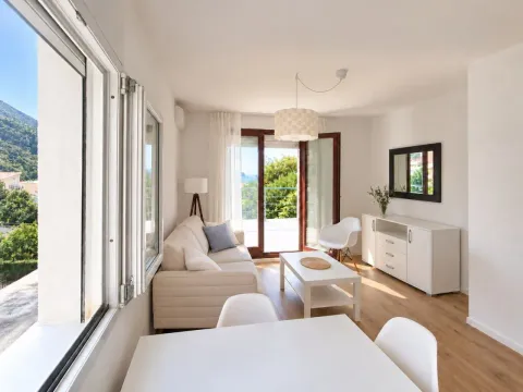 Bright living room with dining area and terrace access. - image 2