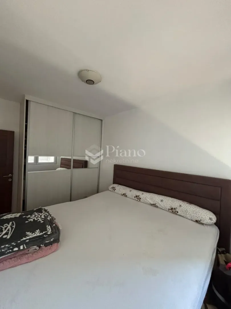 Bedroom with a double bed and a fitted wardrobe.