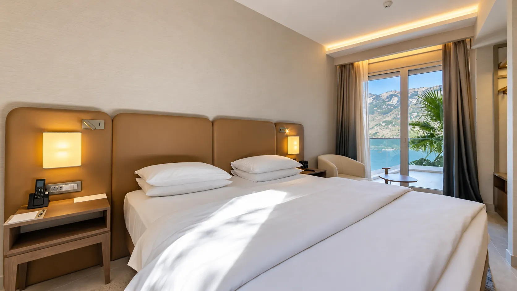 Modern bedroom with a double bed and sea view.