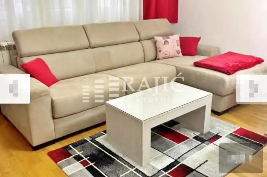 Living room with a beige sectional sofa and a coffee table.