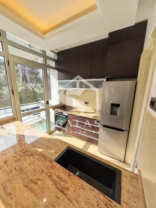 Modern kitchen with built-in cabinetry and access to the terrace.