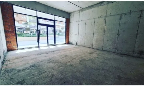 Unfinished commercial space in a shell state with glass doors. - image 5