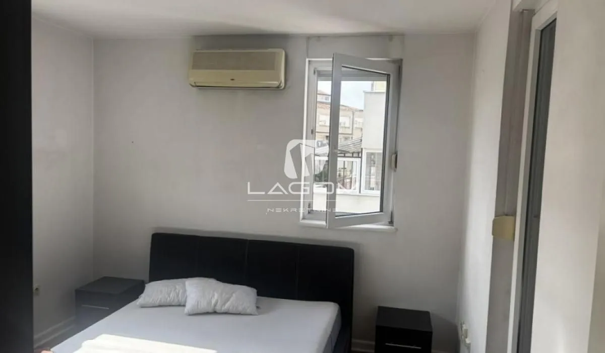 Small bedroom with a double bed, air conditioning unit, and a window.