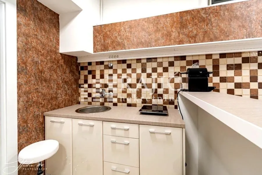 Small kitchen with a sink, countertop, and wall cabinets.
