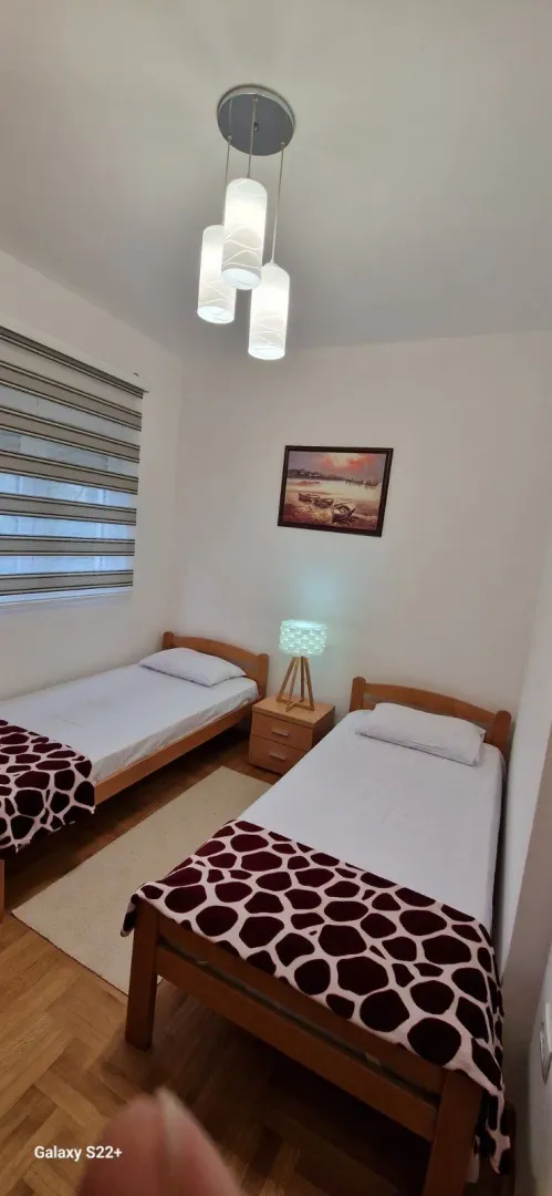 Bedroom with two single beds and a nightstand.