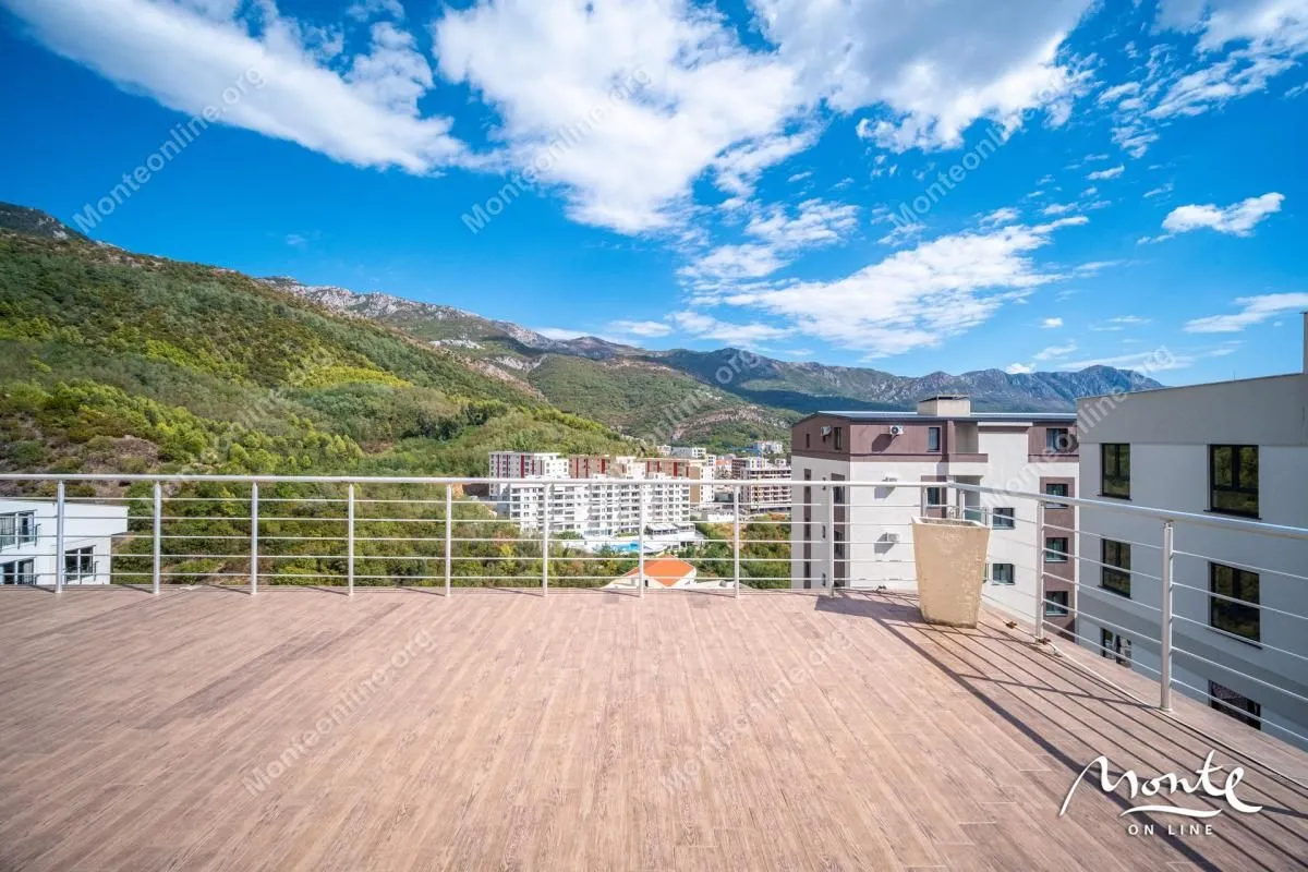 Large terrace with wooden flooring and mountain and city views.