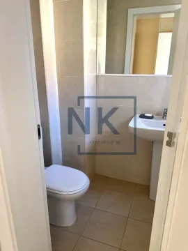 View of the bathroom with a washbasin and toilet. - image 12