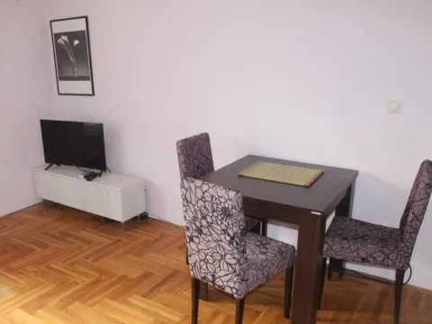Living room with a dining table and a TV. - image 5