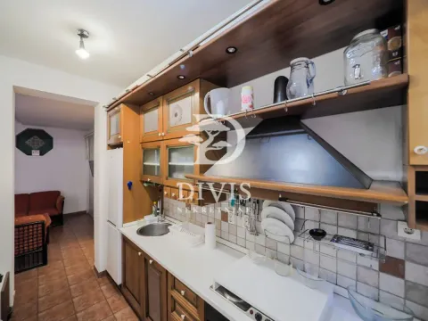 Wooden kitchen cabinets with a countertop and a view of the hallway. - image 7