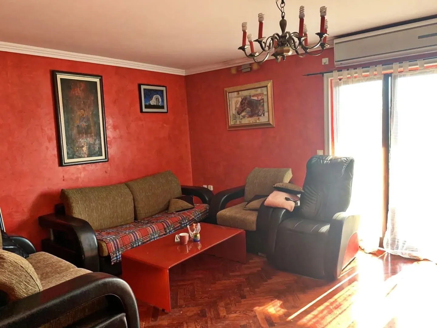 Living room with red walls and furniture.