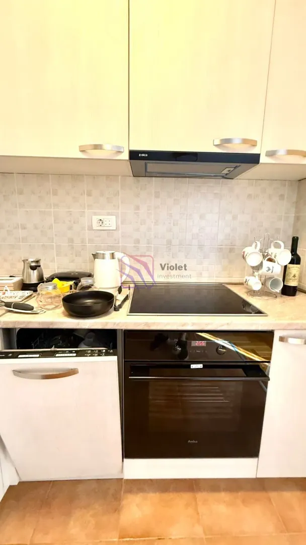 Small kitchen with built-in appliances and a countertop.