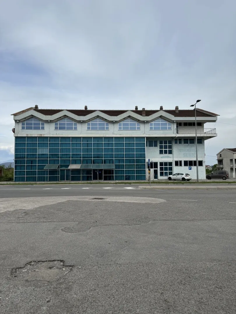 Facade of a commercial building with glass panels.
