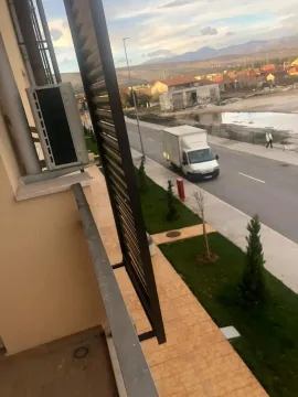 View from the balcony overlooking the street and surrounding landscape. - image 6