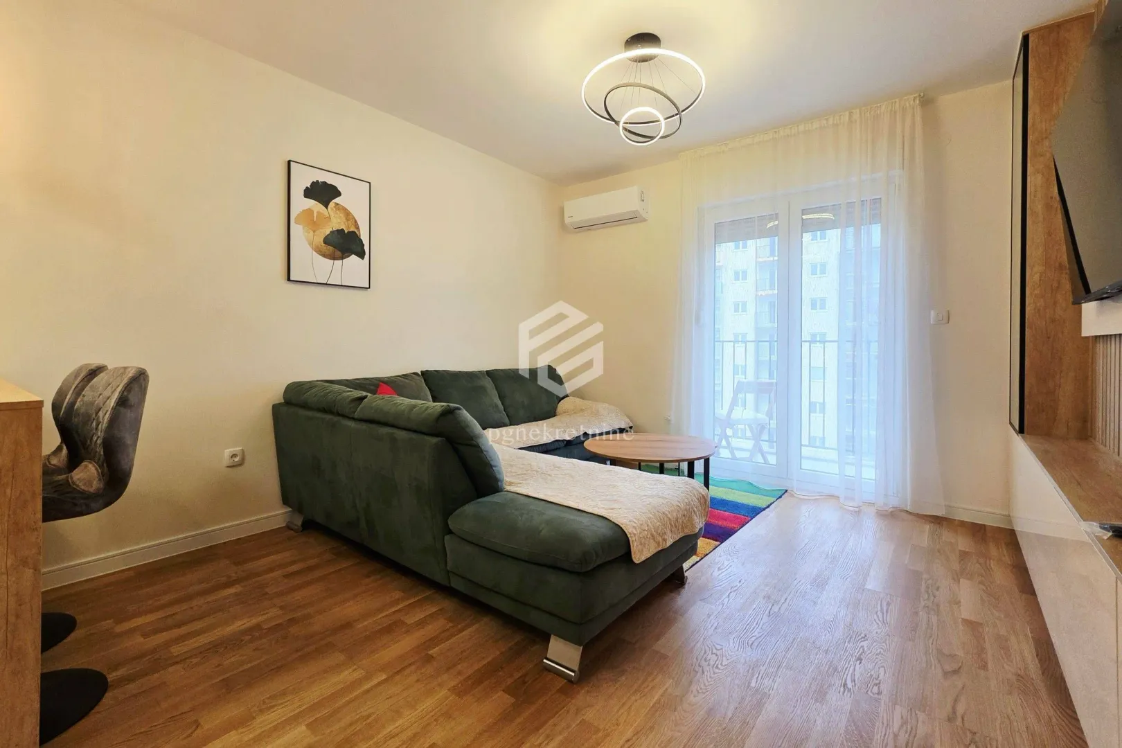 Living room with a sectional sofa, coffee table, and access to the terrace.