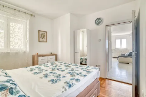 Furnished bedroom with a double bed and wardrobe, looking into another room. - image 12
