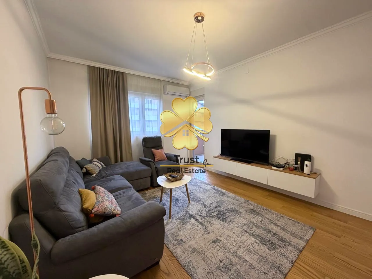 Furnished living room with a sofa and television.