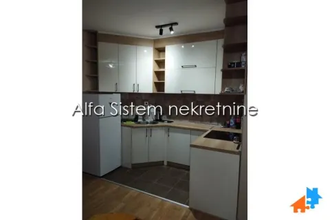 Compact corner kitchen with white cabinets and appliances. - image 9