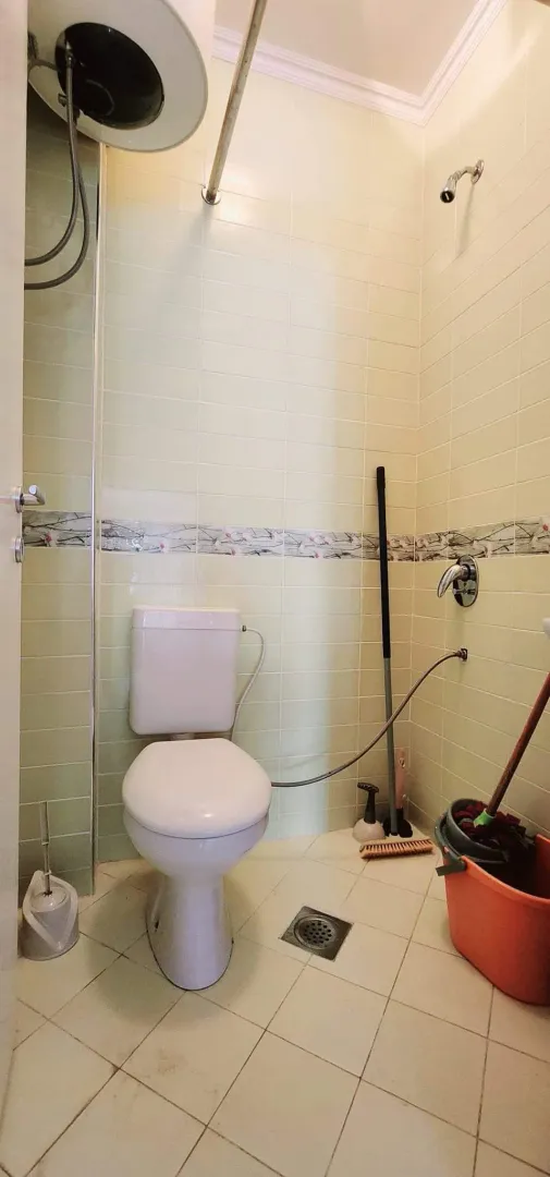 Small bathroom with sanitary facilities and cleaning supplies.