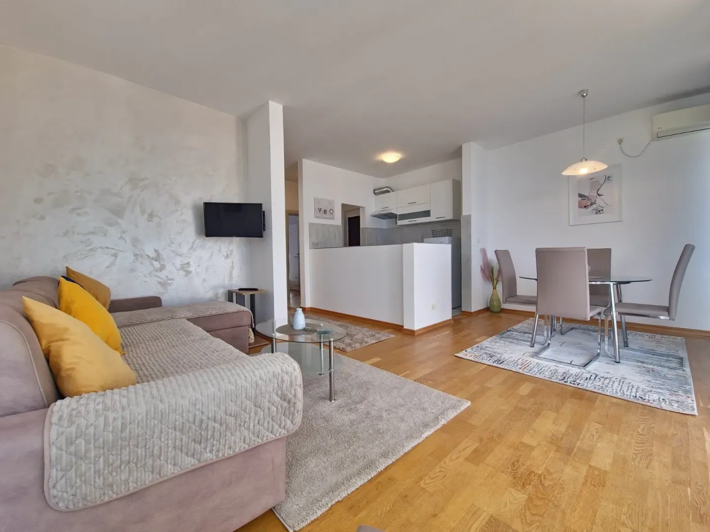 Living room with sofa and dining area.