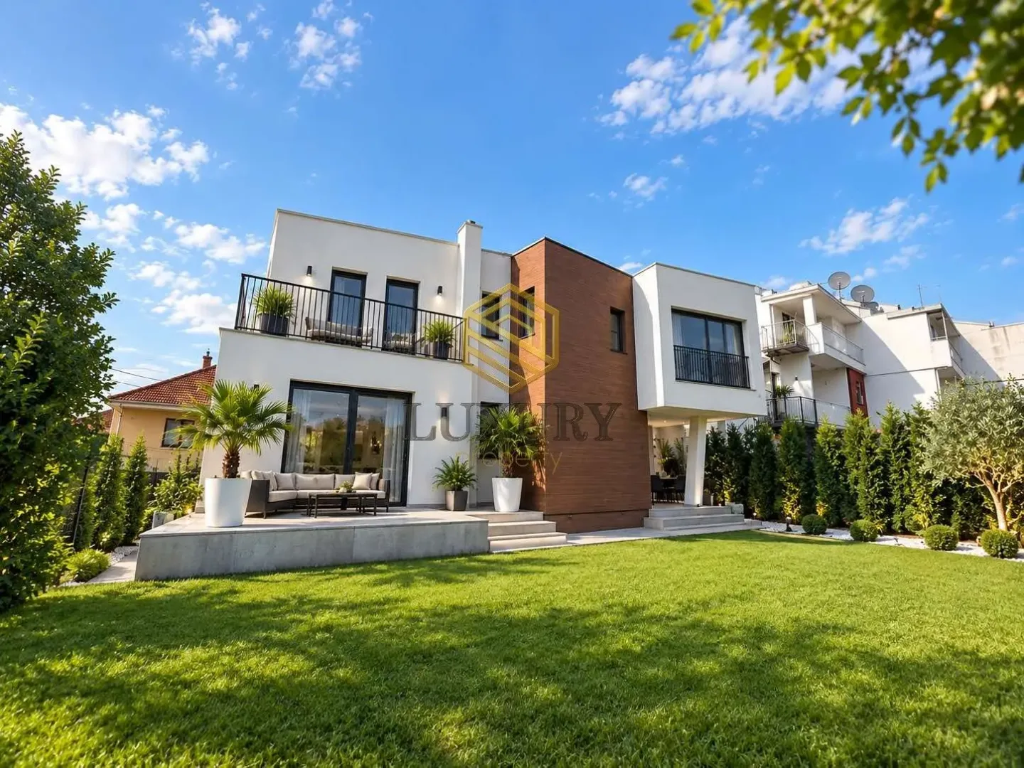 Exterior of a modern villa with a landscaped yard and terrace.