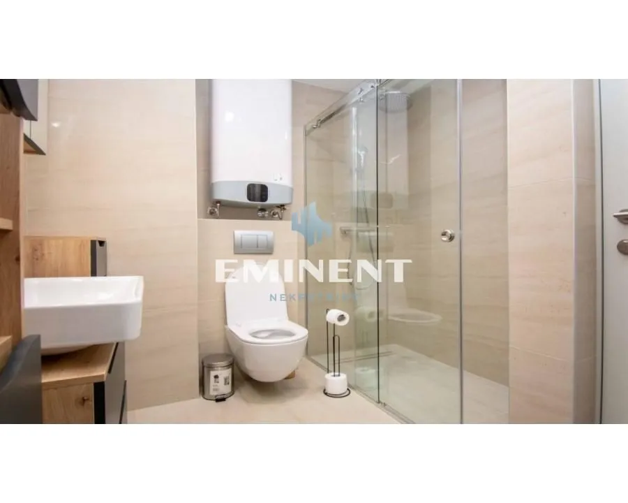 Modern bathroom equipped with a shower cabin and built-in fixtures.