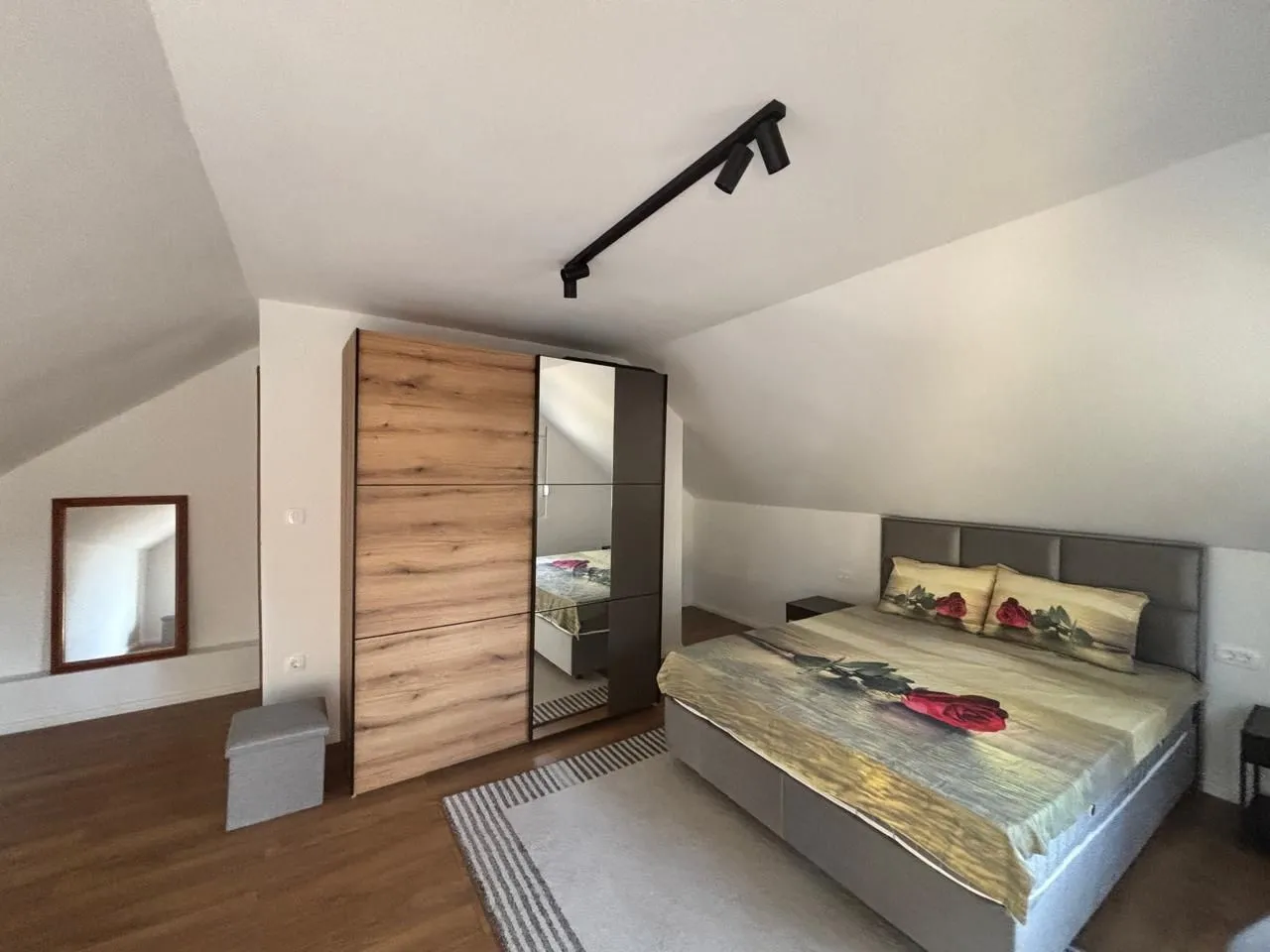 Attic bedroom with a double bed and wardrobe.
