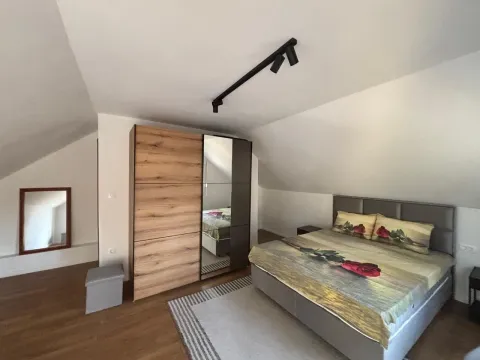 Attic bedroom with a double bed and wardrobe. - image 2