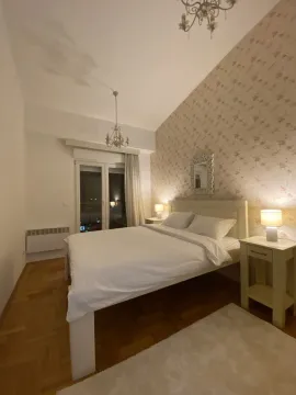 Bright bedroom with a double bed and nightstands. - image 7