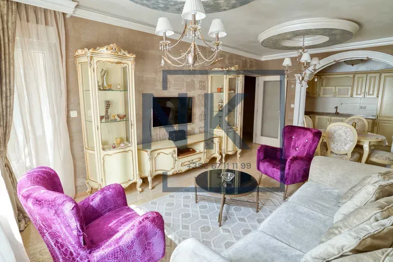 Spacious living room with classic furniture and a view of the dining area.