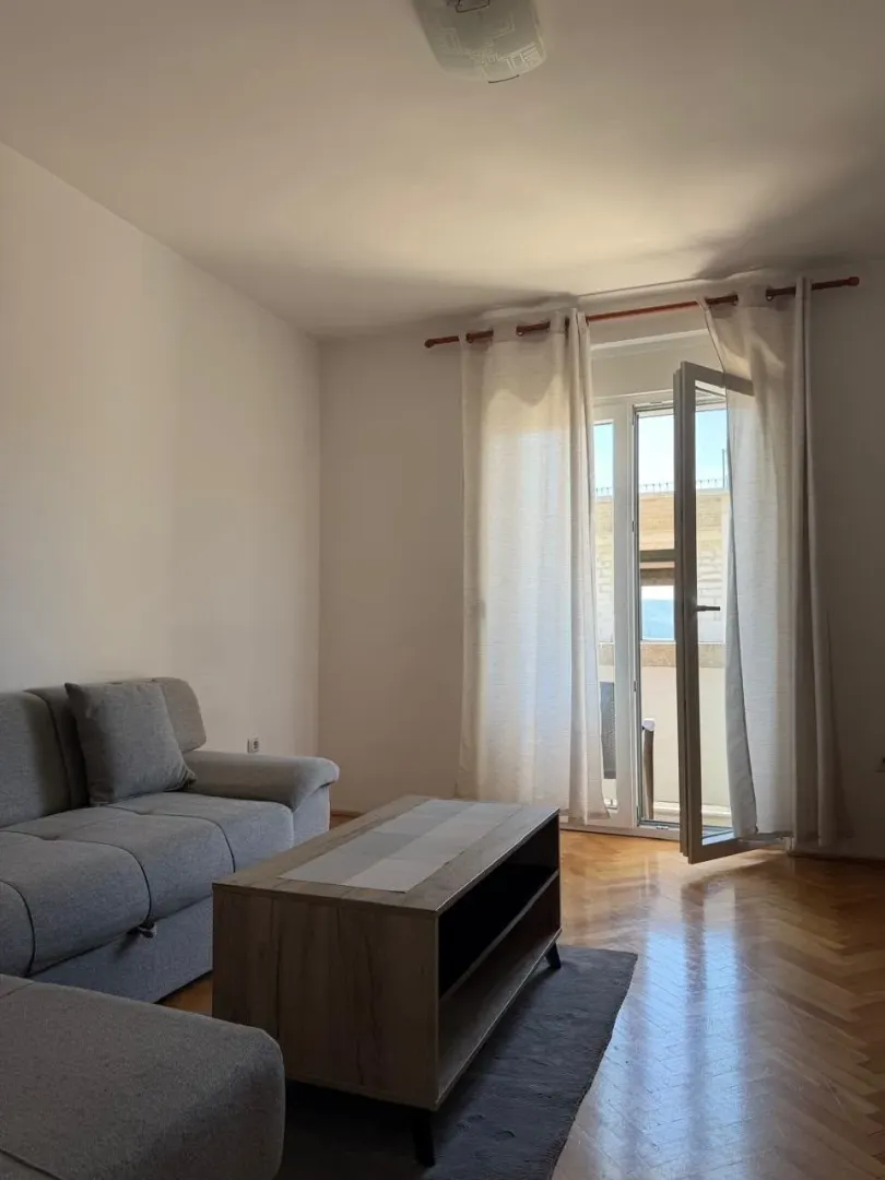 Living room with a sofa, coffee table, and access to the terrace.