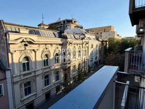 View from the balcony overlooking old city architecture and the street. - image 20