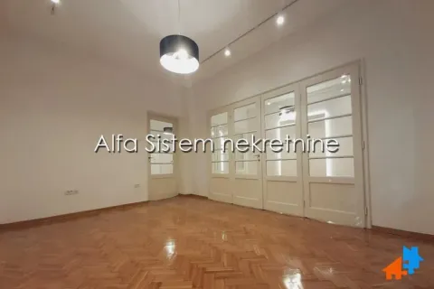 Empty room with parquet flooring and wooden doors. - image 9