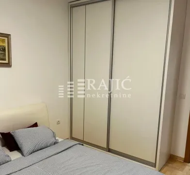 Bedroom with a bed and a large fitted wardrobe. - image 9