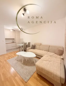 Living room with a sofa, coffee table and dining area in the background. - image 5